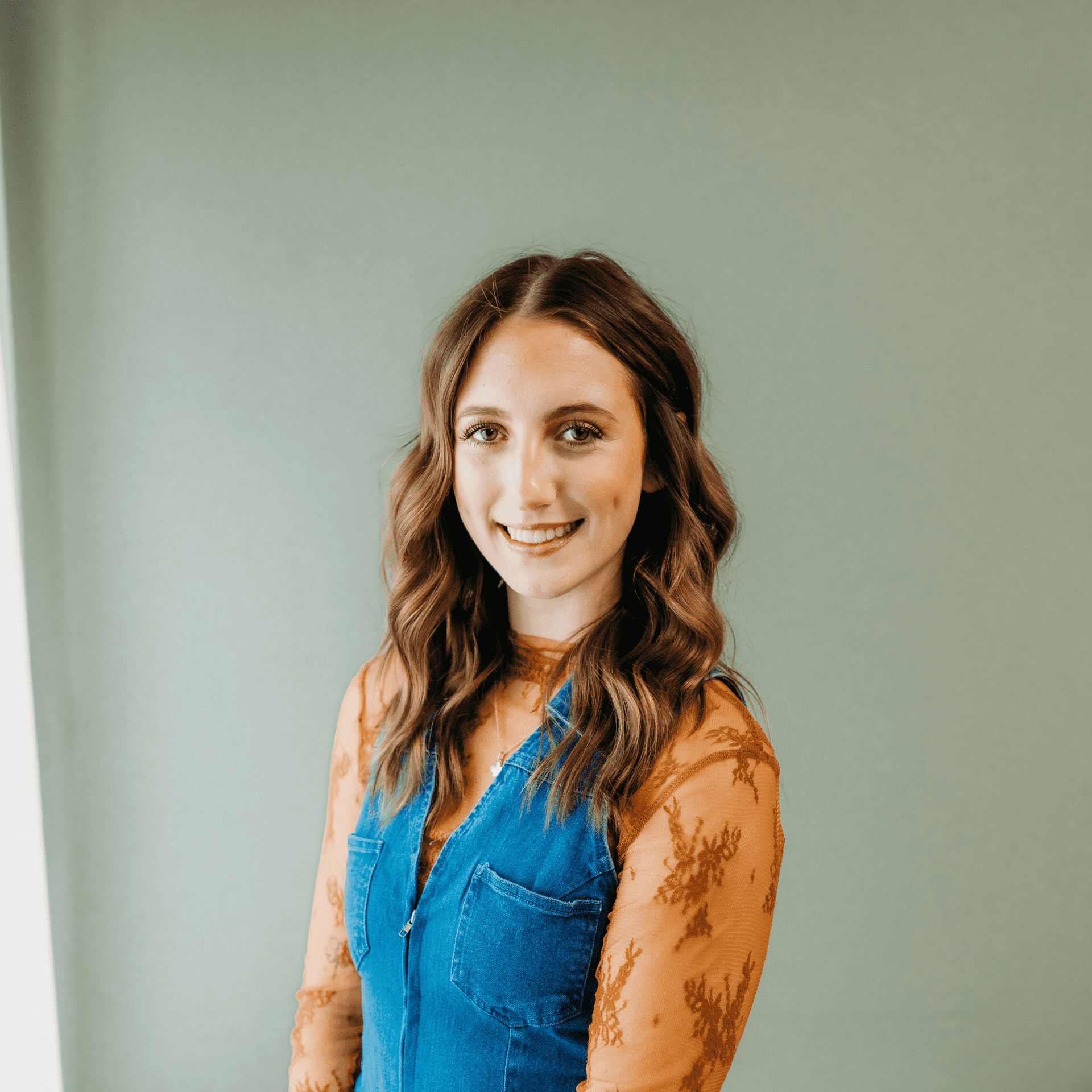 Portrait of Avery Feasel, a professional stylist at Tangles Salon, showcasing their expertise and style.