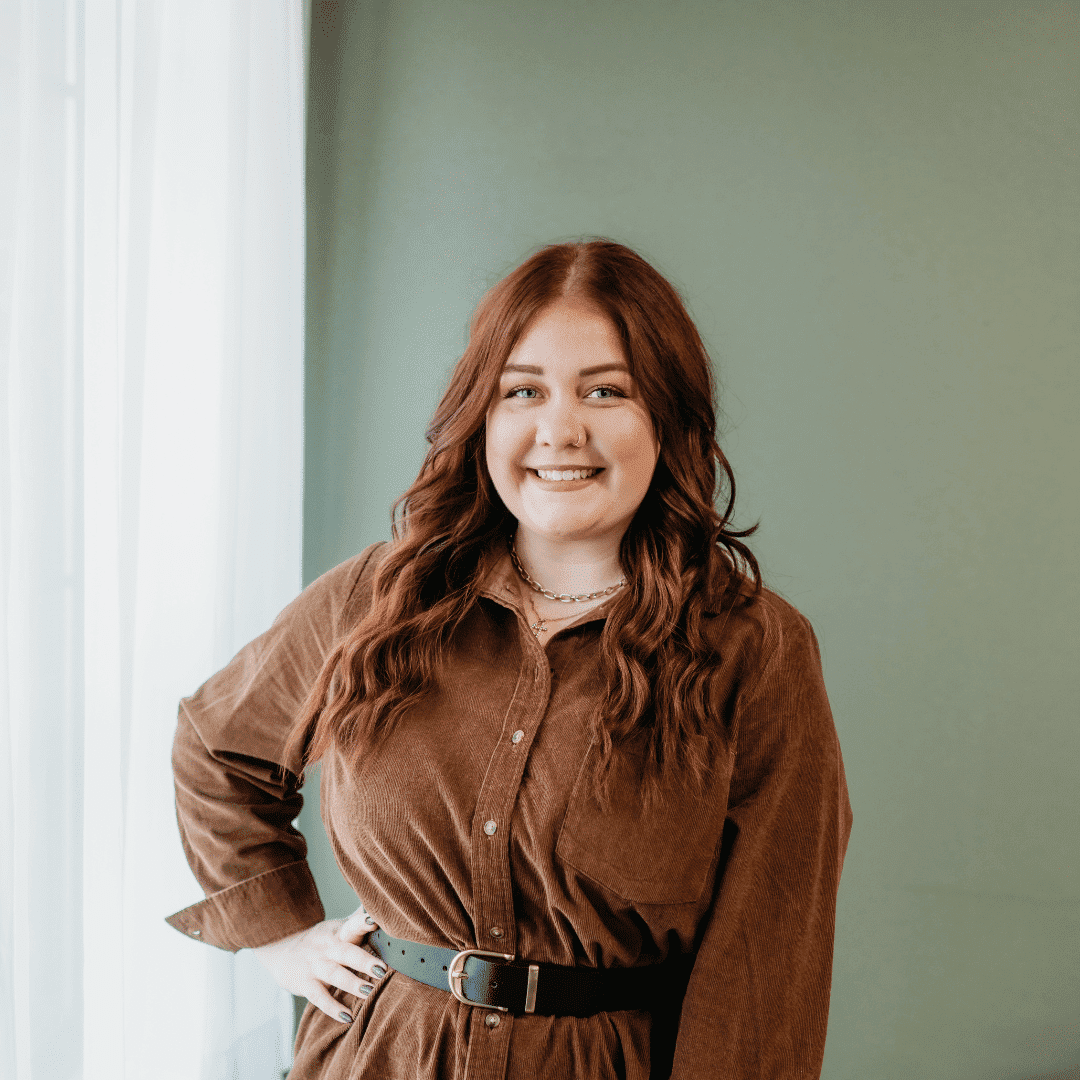 Portrait of Ashley Reinhart, a professional stylist at Tangles Salon, showcasing their expertise and style.