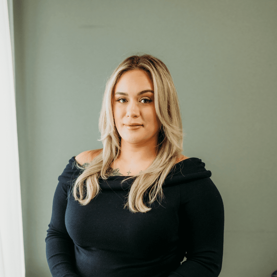 Portrait of Kahla Bliss, a professional stylist at Tangles Salon, showcasing their expertise and style.